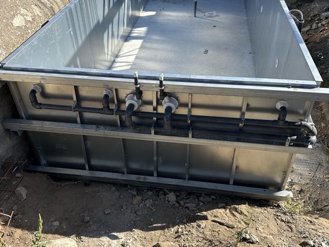 Raised pool of galvanised panels with pipework
